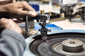 diamond polishers at work at the wheel in the diamond polishing factory