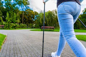 Nordic walking -  mid-adult woman exercising in city park
