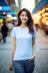 Female asian model wearing plain clothes on city streets.