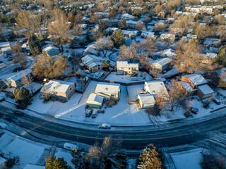winter morning over a residential area of Fort Collins in northern Colorado with fresh snow, aerial view