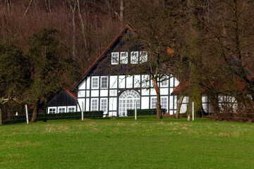 Fototapeta premium Charming house surrounded by greenery in a scenic rural landscape