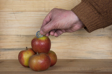 The price we pay. An apple, embedded with monetary value, points to the growing challenge of...
