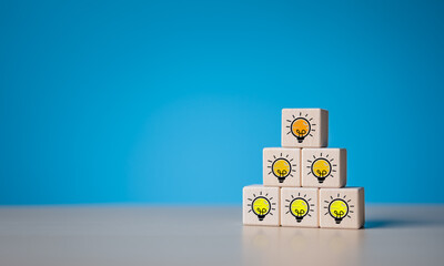 Brainstorming creative ideas and innovation concept. Pyramid stacked wooden cube blocks with...