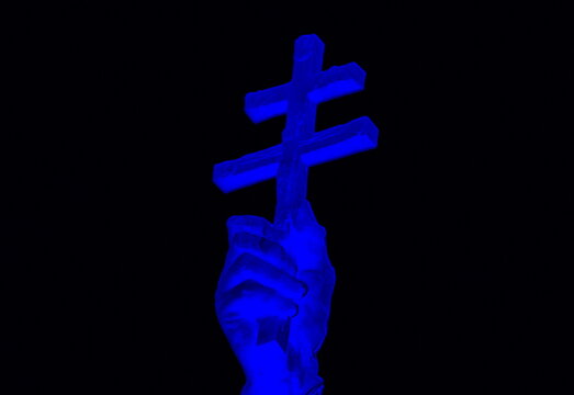 The image of a religious Christian cross in the hand.