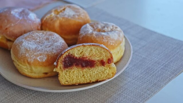 Sweet Delicious Traditional Polish Glazed Doughnut Paczek Filled with Sweet Jam Marmalade Prepared for Dessert on Fat Thursday Celebration before Ash Wednesday and Lent