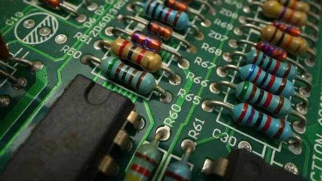 Macro Shot of Automatic Pick and Place machine quickly installs Components on Circuit Board. While board moving through Assembly Line. Electronics and Circuit board Manufacturing Factory.