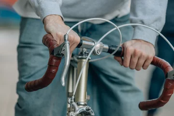 Foto op Aluminium close-up of hands of young man on handlebars of vintage bicycle © carballo