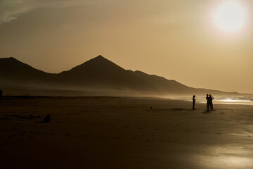 Fototapeta na wymiar Sunset on Cofete beach in Fuerteventura in Jandia Natural Park with silhouettes and mountains