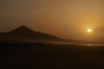 Obraz premium Sunset on Cofete beach in Fuerteventura in Jandia Natural Park with silhouettes and mountains