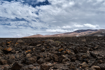 Arid land with mountains and clouds on sky in Betancuria, Fuerteventura, Spain