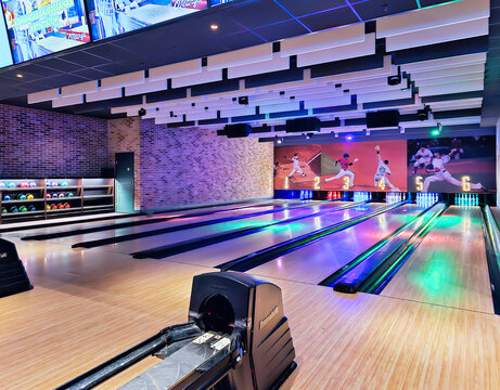 LATVIA, RIGA, 05, FEBRUARY, 2024: Lanes in a bowling alley and bowling balls in the rack in the recreation area at Akropole shopping mall, Riga. Latvia 