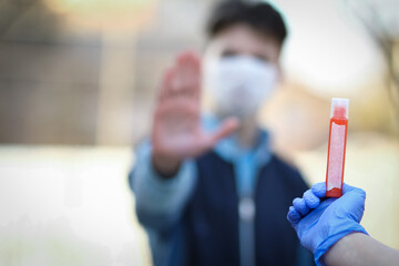 A Coronavirus blood sample in hands 2019-2020. Crown virus outbreak. Epidemic viral respiratory...