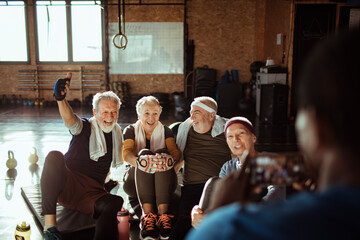 Diverse senior people taking a group photo in gym