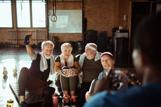 Diverse senior people taking a group photo in gym