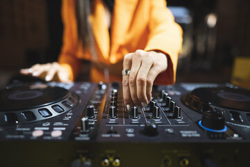 a DJ plays music on a controller at a party