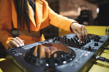 a DJ plays music on a controller at a party