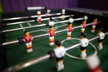 A close-up of the table football game of football figures on the field