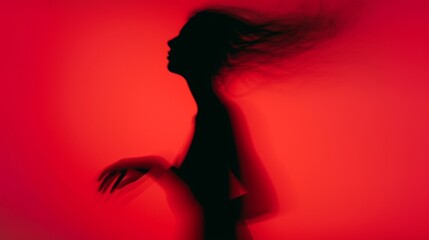 Woman blurred silhouette on a red background. Elegant outline of a woman in motion out of focus
