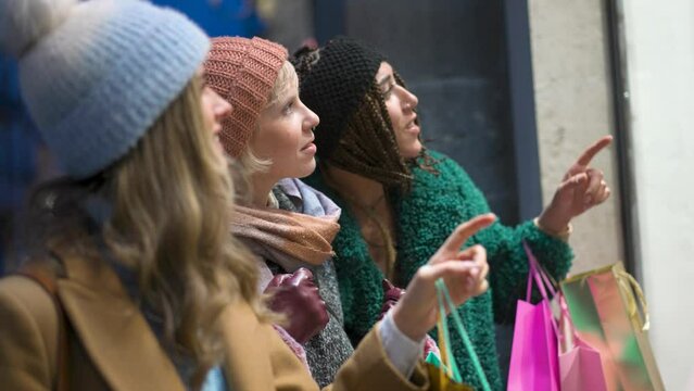 Women Fascinated by Fashionable Window Display