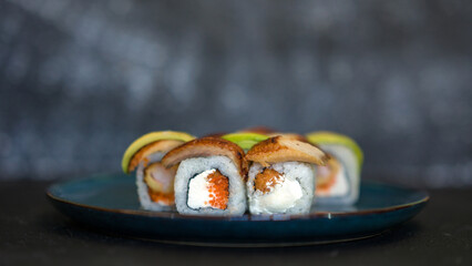 Sushi rolls are served on a plate. soy sauce. Delicious seafood food.