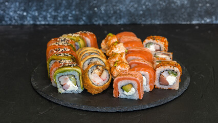 Sushi rolls are served on a plate. soy sauce. Delicious seafood food.