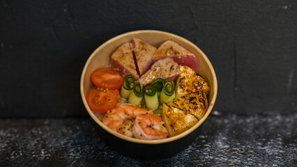 Seafood salad served on a beautiful plate. Salad with king prawns and prosciutto.