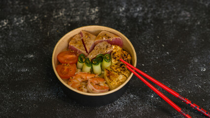 Seafood salad served on a beautiful plate. Salad with king prawns and prosciutto.