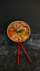 Seafood salad served on a beautiful plate. Salad with king prawns and prosciutto.