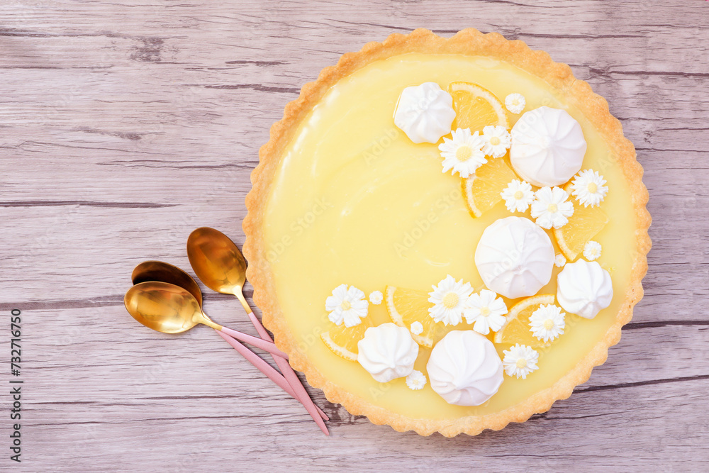 Aufkleber spring lemon tart with white chocolate flowers and meringue. top down view over a white background.