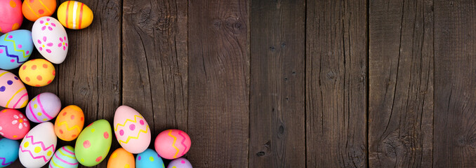 Colorful Easter Egg corner border over a dark wood banner background. Copy space.
