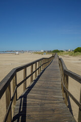 Fototapeta premium Wooden walkway extends along the beach of the port of Mar del Plata.