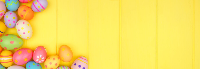 Colorful Easter Egg corner border over a bright yellow wood banner background. Copy space.