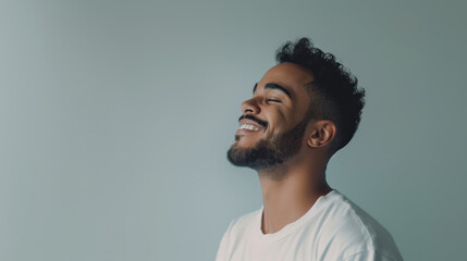 Obraz premium Confident and successful young African American man smiling exuding positivity and joy against grey background with copy space fot text