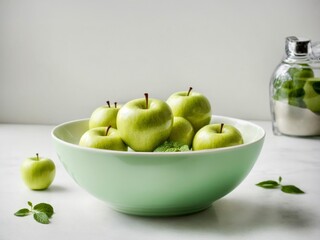 Green apples in white bowl on white table. Green apples on white background. Healthy eating and food concept. 