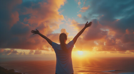 Fototapeta premium A person can't help but raise their hands in celebration at sight of the amazing sunset