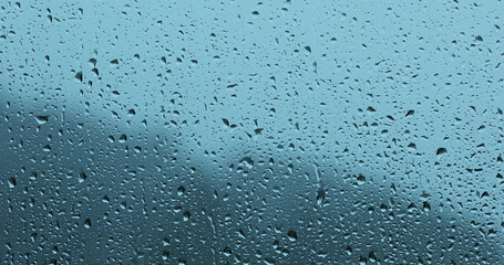 Rain drops closeup on home glass window.	
