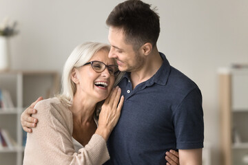Happy son man embracing laughing older mature mom with love, care, gratitude. Mother and kid...