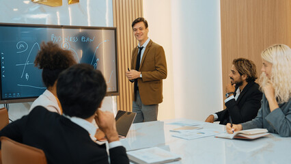 Presentation in ornamented meeting room with business professionals attending to project...