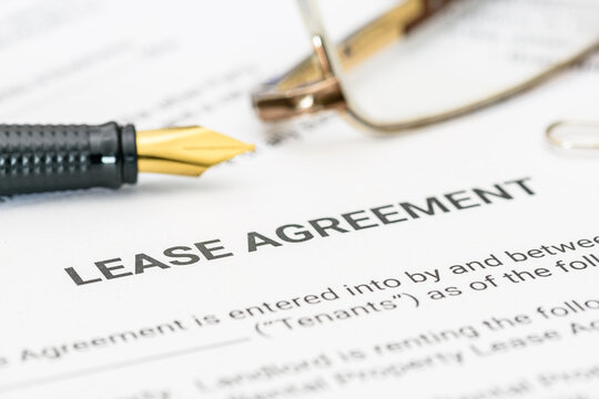 Business legal document concept : Pen and glasses on a lease agreement form. Lease agreement is a contract between a lessor and a lessee that allow lessee rights to use of a property owned by lessor.