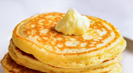 Pancakes fluffy stack on white plate, delicious food. Homemade freshly baked pancakes for American...