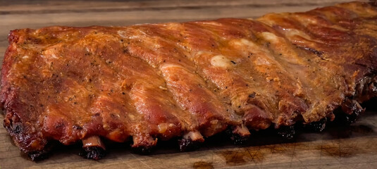 Beef ribs meat part with spices on wood background. Homemade cooking beef for restaurant, menu, advert or package, close up, selective focus