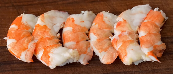 Shrimp raw on wood background. Homemade cooking shrimp, serving food for restaurant, menu, advert or package, close up, selective focus