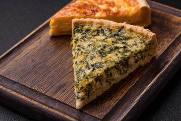 Delicious crispy quiche cut into slices with cheese, broccoli, tomatoes