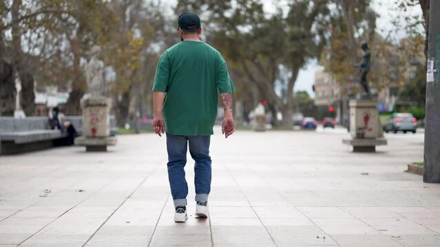 breakdancer guy performing floor based footwork on the street