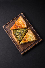 Delicious crispy quiche cut into slices with cheese, broccoli, tomatoes