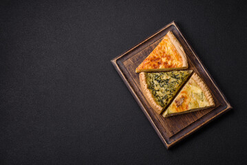 Delicious crispy quiche cut into slices with cheese, broccoli, tomatoes