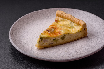 Delicious crispy quiche cut into slices with cheese, broccoli, tomatoes