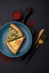 Delicious crispy quiche cut into slices with cheese, broccoli, tomatoes