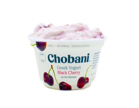 Ocala, Fl January 9, 2024 Container of Chobani brand Greek yogurt black cherry flavor fruit on the bottom single container opened showing contents,  isolated on white background