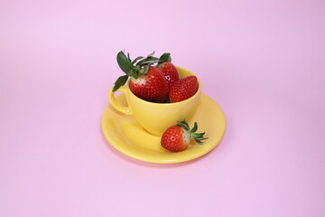 strawberries in a yellow cup in spring 